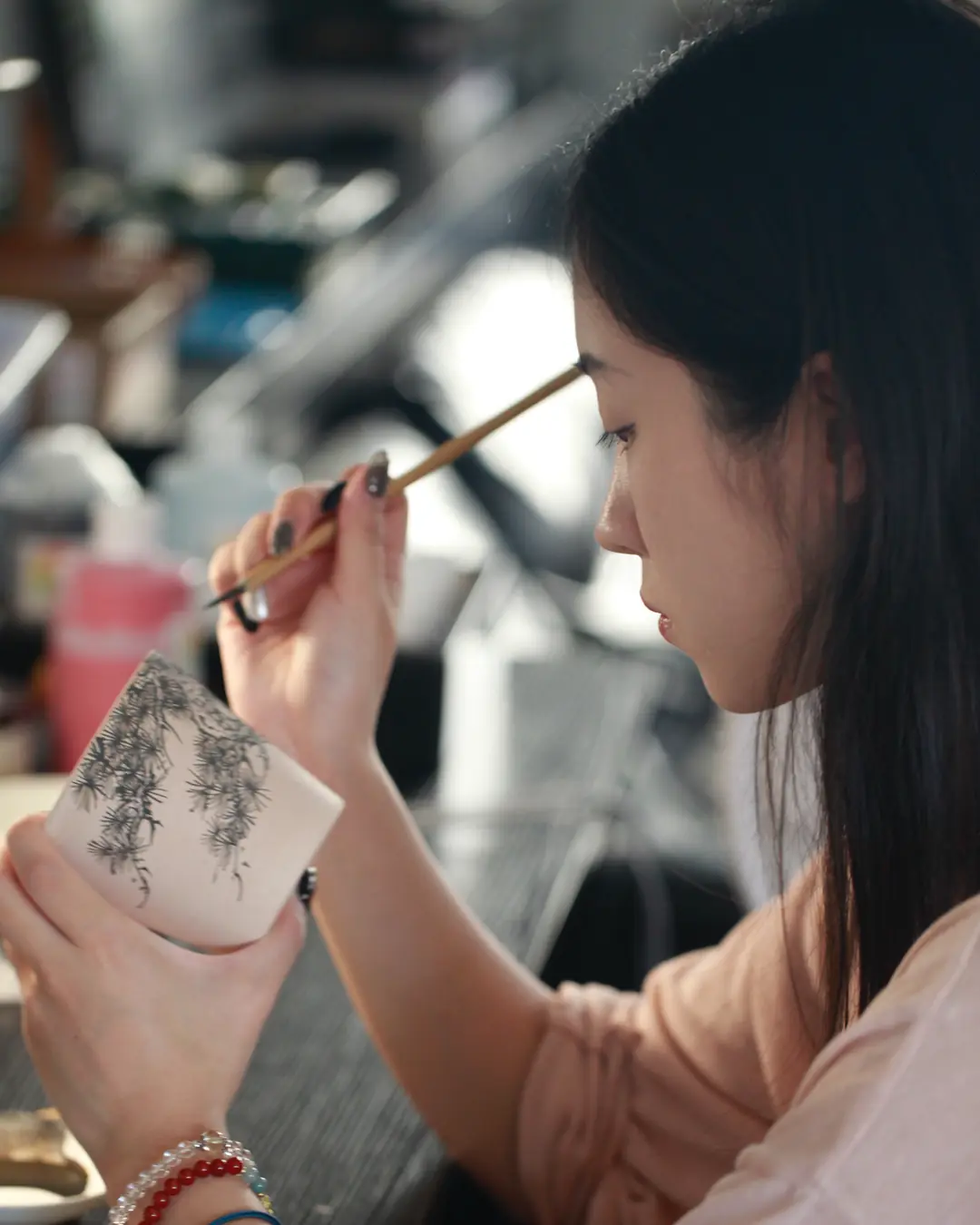 Zhao Ruyan carving a pine branch into a leather-hard cup