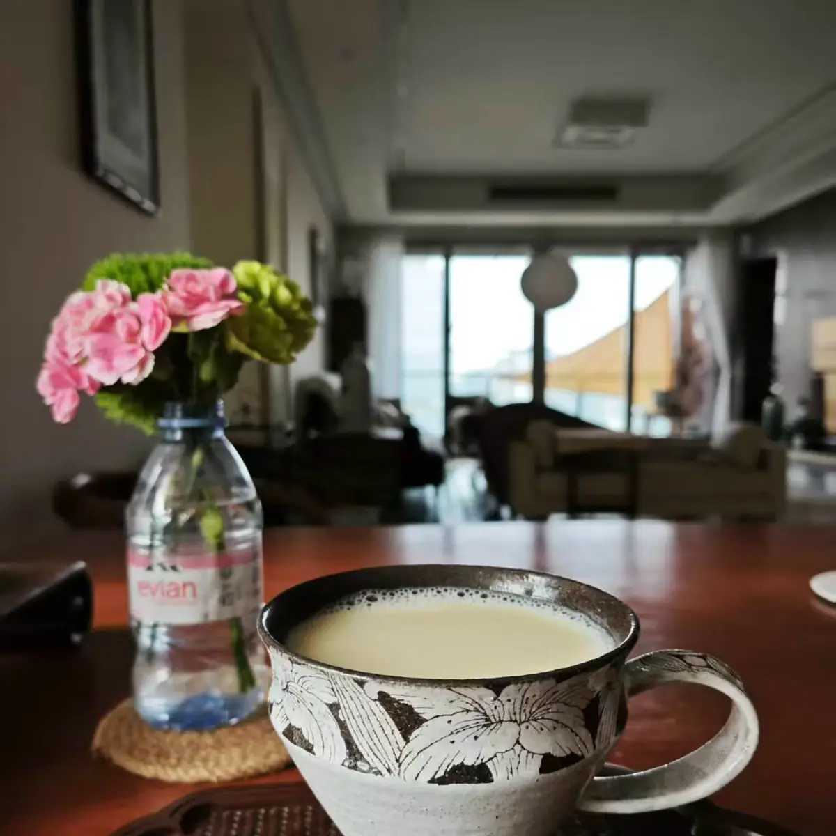 Morning coffee in a carved lily cup, resting on a woven tray