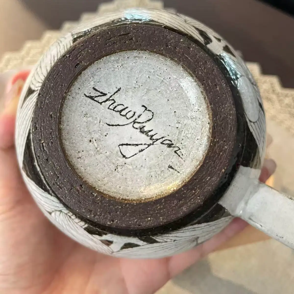 The base of the cup, Zhao Ruyan signed by hand into a circle of pale glaze inside the unglazed foot ring
