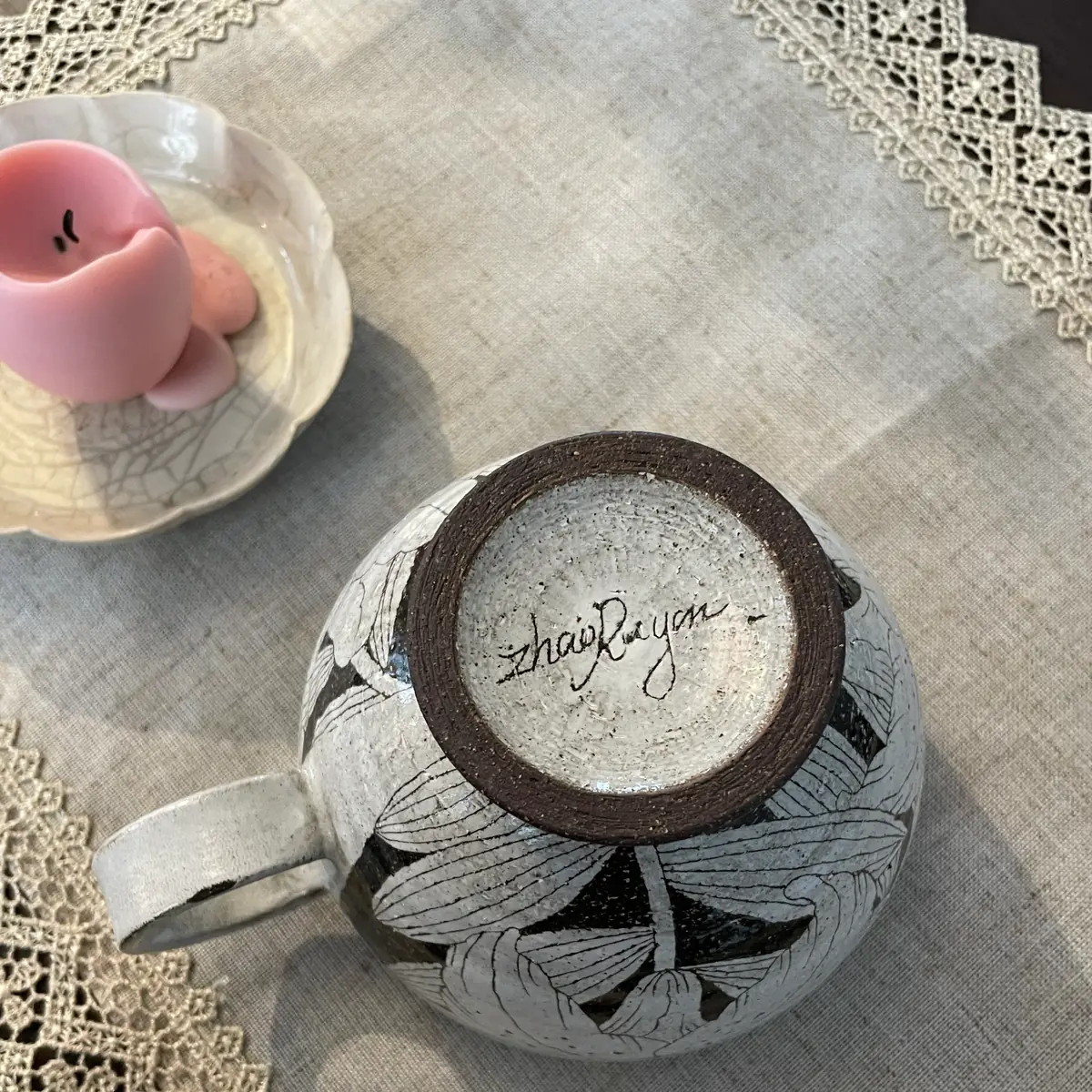 The base of the cup, Zhao Ruyan signed by hand into a pale circle inside the unglazed foot ring